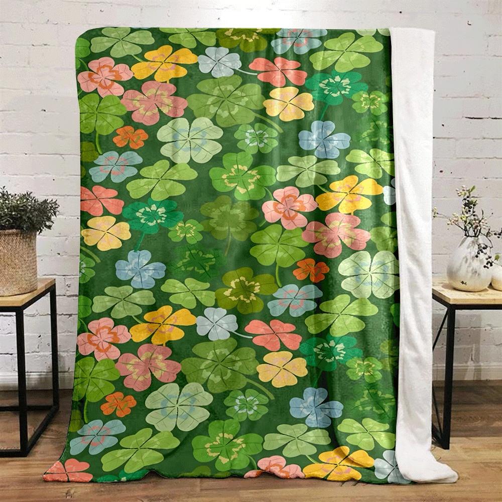 Colorful clovers and flowers scattered on a green background. for all seasons blanket lunch break throw gift