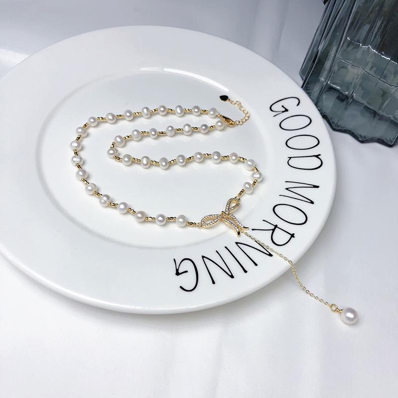 Elegant White Pearl Necklace with Bow Design and Spacer Beads