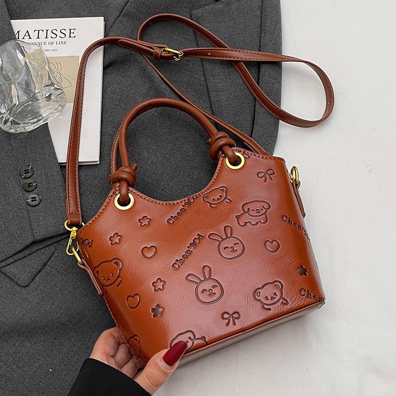 2025 new niche embossed fashion personalized portable bucket bag high-end commuter versatile women's messenger bag