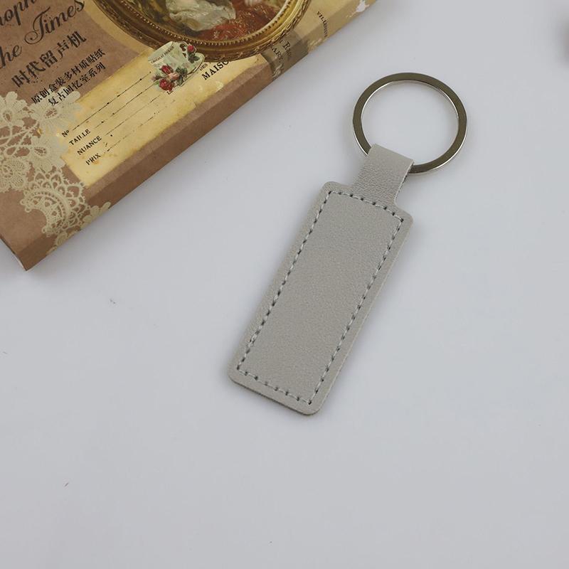 

1 шт. двухсторонний брелок из искусственной кожи для автомобиля, небольшой подарочный металлический кулон из искусственной кожи, однотонный автомобильный брелок, простые брелки для ключей серый
