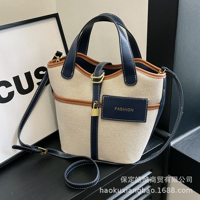 Canvas niche contrasting color handbag women's 2025 summer new Korean fashion shoulder messenger bag versatile bucket bag