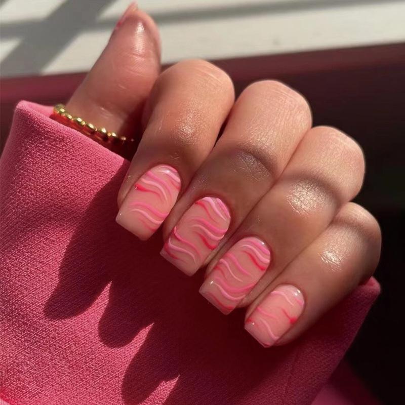 

Nail art piece, cute pink, red contrasting color, striped, wavy short, wearing nail, wearing nail art finished product.