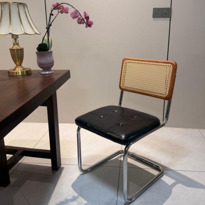 Elegantly crafted armless rattan dining chair in retro pastoral style, perfect for cafes, guesthouses, and vintage settings.