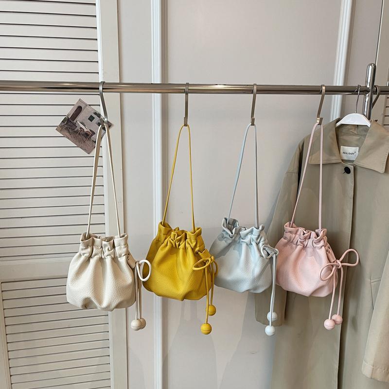 2026 New Drawstring Bucket Bag for Women Soft Leather Crossbody Bag with Ball Charm Mini Shoulder Handbag for Daily Shopping