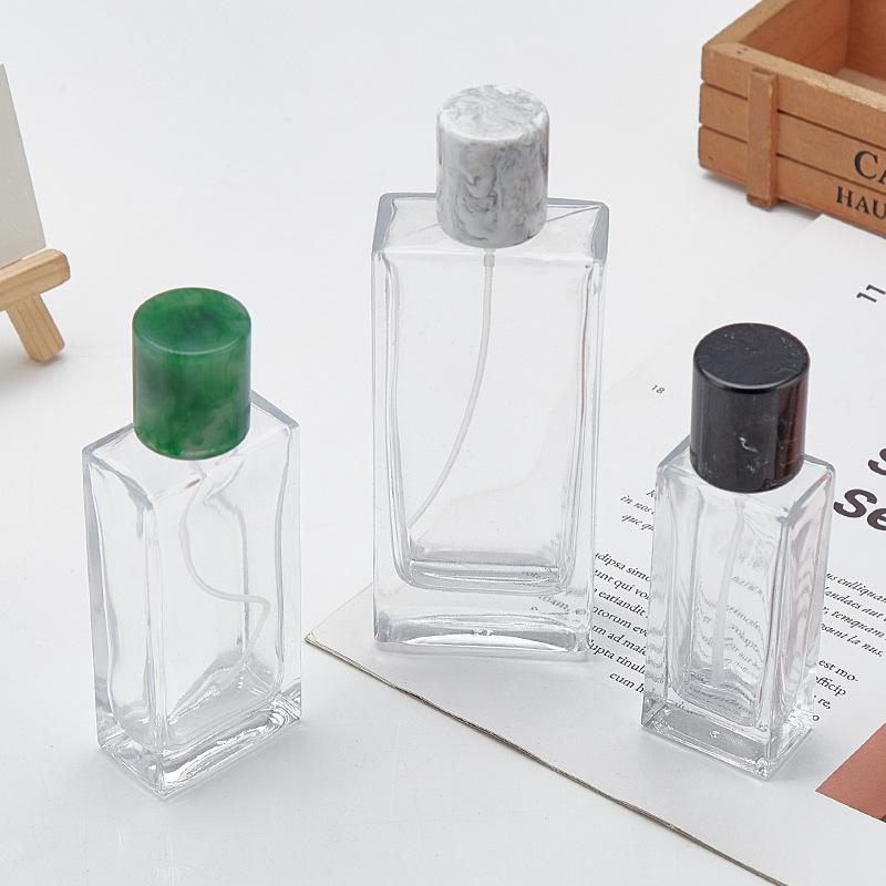 In-Stock Transparent Bayonet Glass Perfume Bottle with Resin Lid and Spray Refill