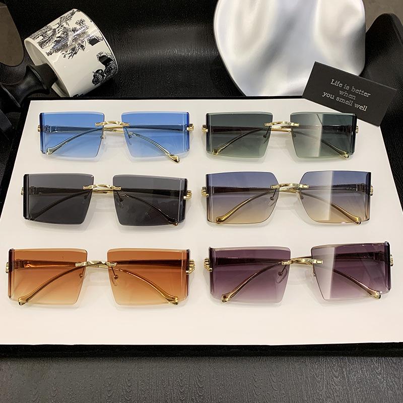 New European and American curved lenses leopard head metal frameless trimmed high-end sunglasses European and American sunscreen glasses