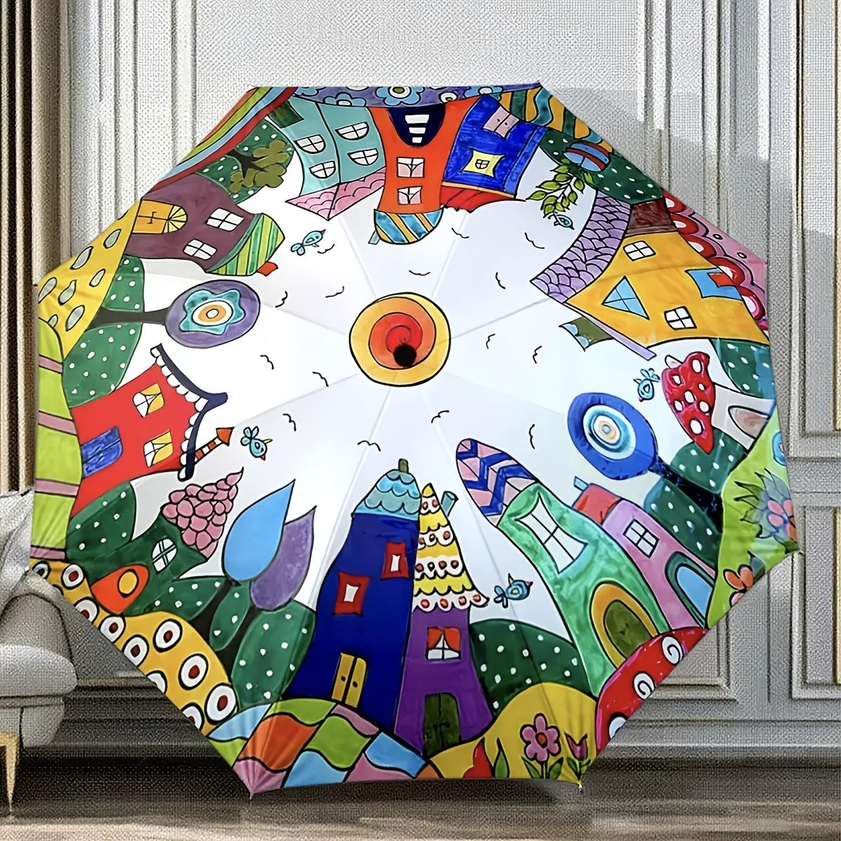 A Colorful Fantasy House Patterned Folding Umbrella with a Sun Shape in The Center. It Features a Portable And Foldable Design, Making It a