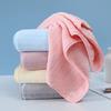 Lavez votre visage avec une serviette de bain unie en velours corail doux et absorbant.
