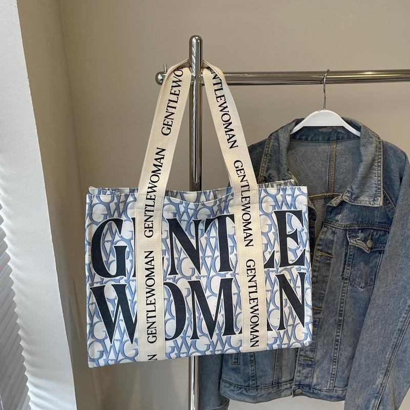 Large capacity alphabet canvas bag women's 2025 new fashion niche shoulder bag college student class commuter bag
