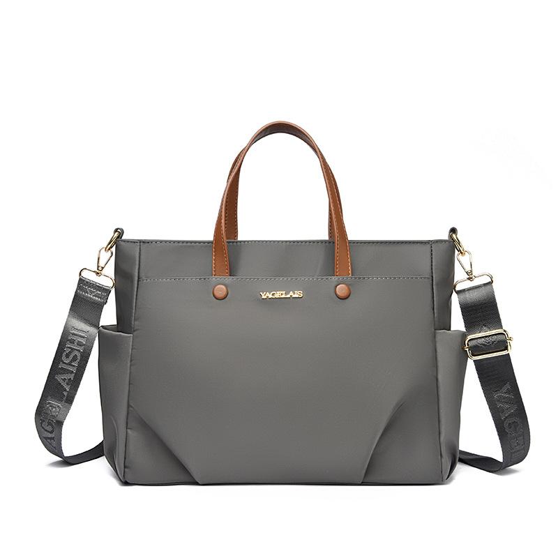 A Laptop Bag, A Lady Carrying A Business Briefcase and Slung A Commuter Tote Bag Across Her Shoulder