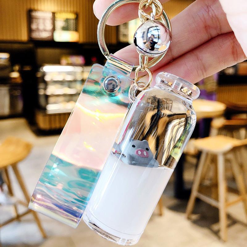 

Floating Pig Milk Keychain With Purple Bell And Acrylic Liquid Sand Design GraySilver