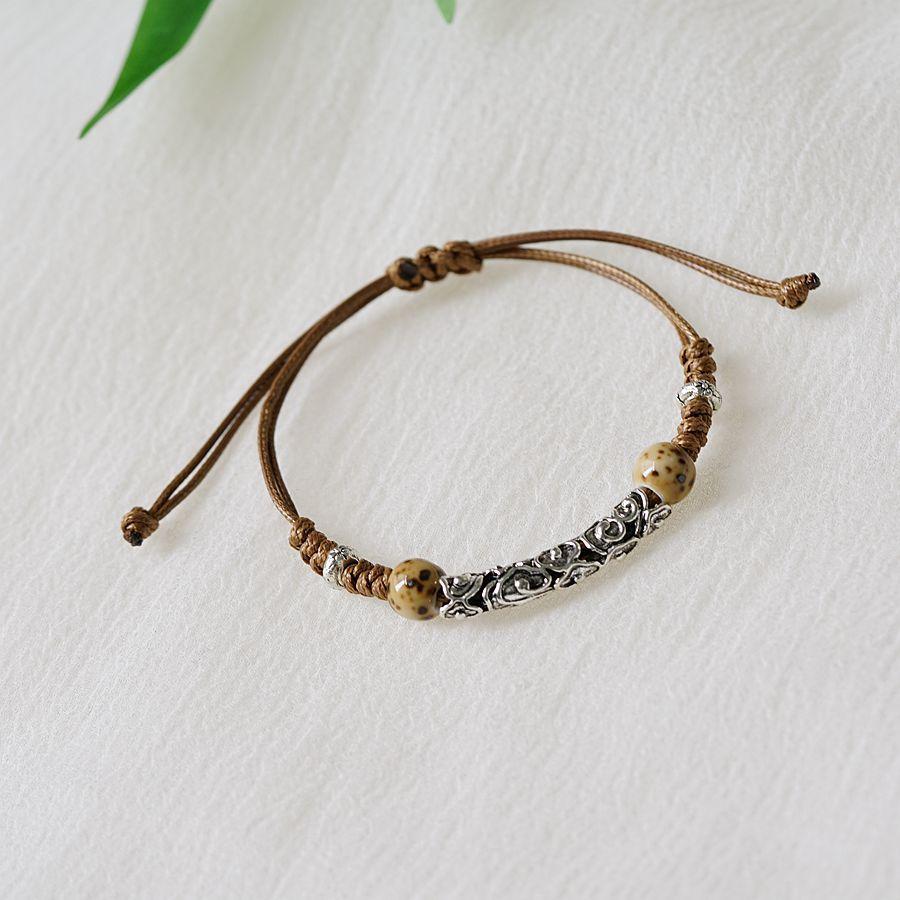 

Ancient style literary and artistic weaving hollow auspicious cloud alloy ceramic bracelet women s ethnic style adjustable new Chinese