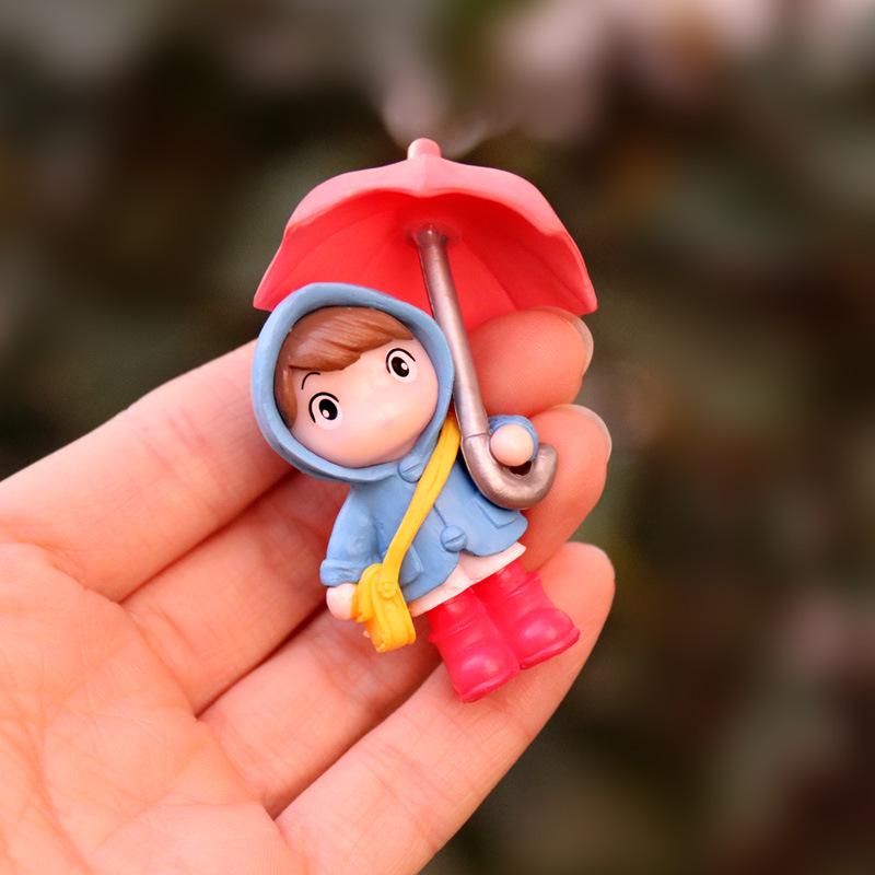 Cartoon Girl Raincoat Figurine: Cute Umbrella-Holding Doll for Desktop or Car Decor