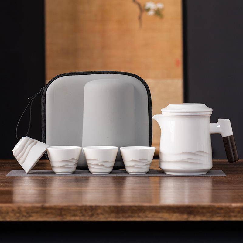 

High-grade suet jade porcelain travel tea set ceramic one pot four cups outdoor portable light luxury business commemorative gifts