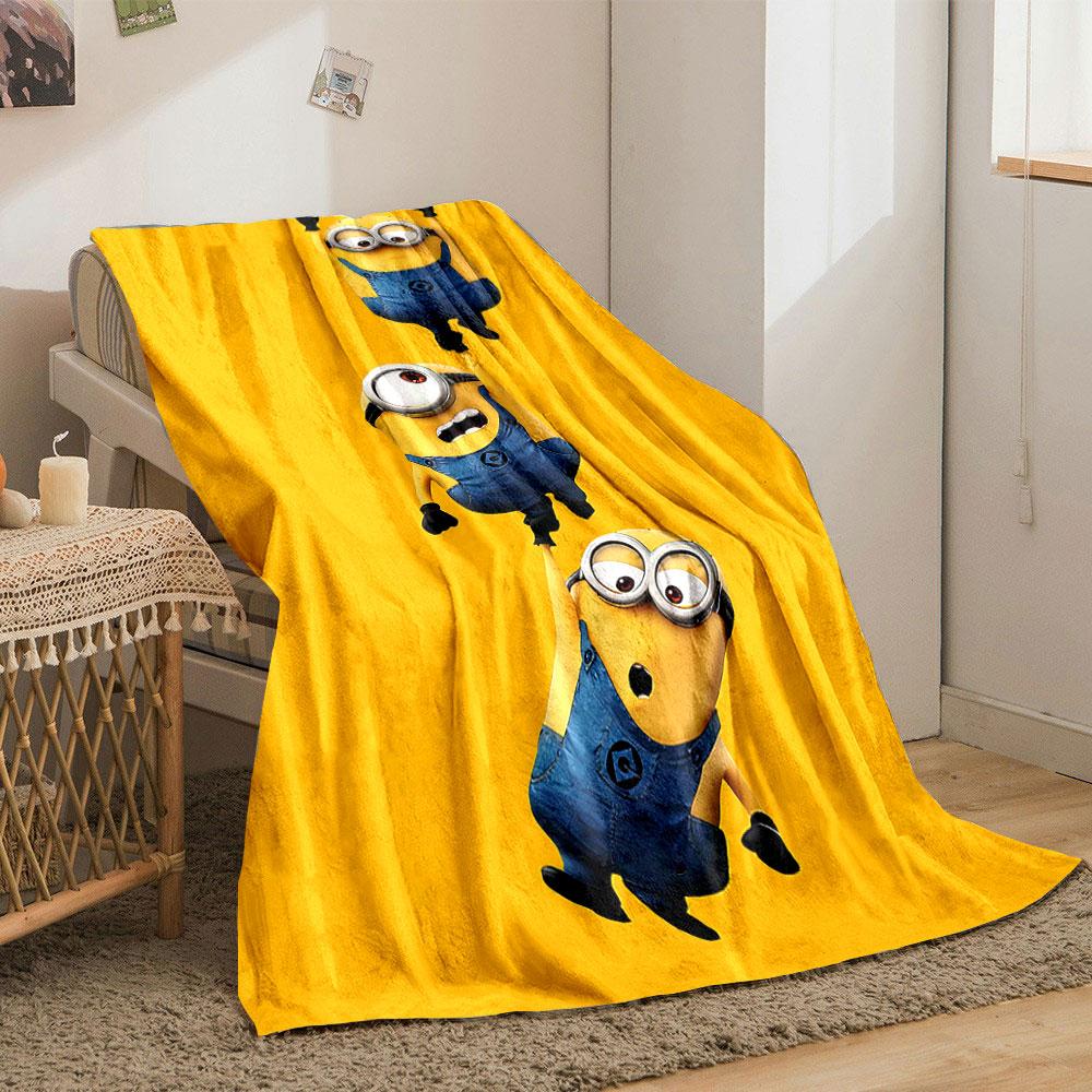 Three Minions in blue overalls hanging from each other on a yellow background. for all seasons blanket lunch break throw gift