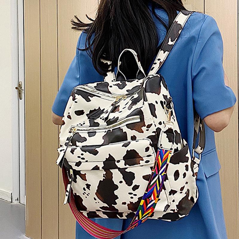 Neuer PU Retro Rucksack mit großer Kapazität für Reisen, Kuhmuster, schlichter britischer Stil, schräg über die Schulter tragbar, für Damen