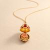 Enamel Egg Pendant Necklace with Hinged Opening, Collarbone Chain, Gold-Tone Chain, and Easter Outfit Styling for Women