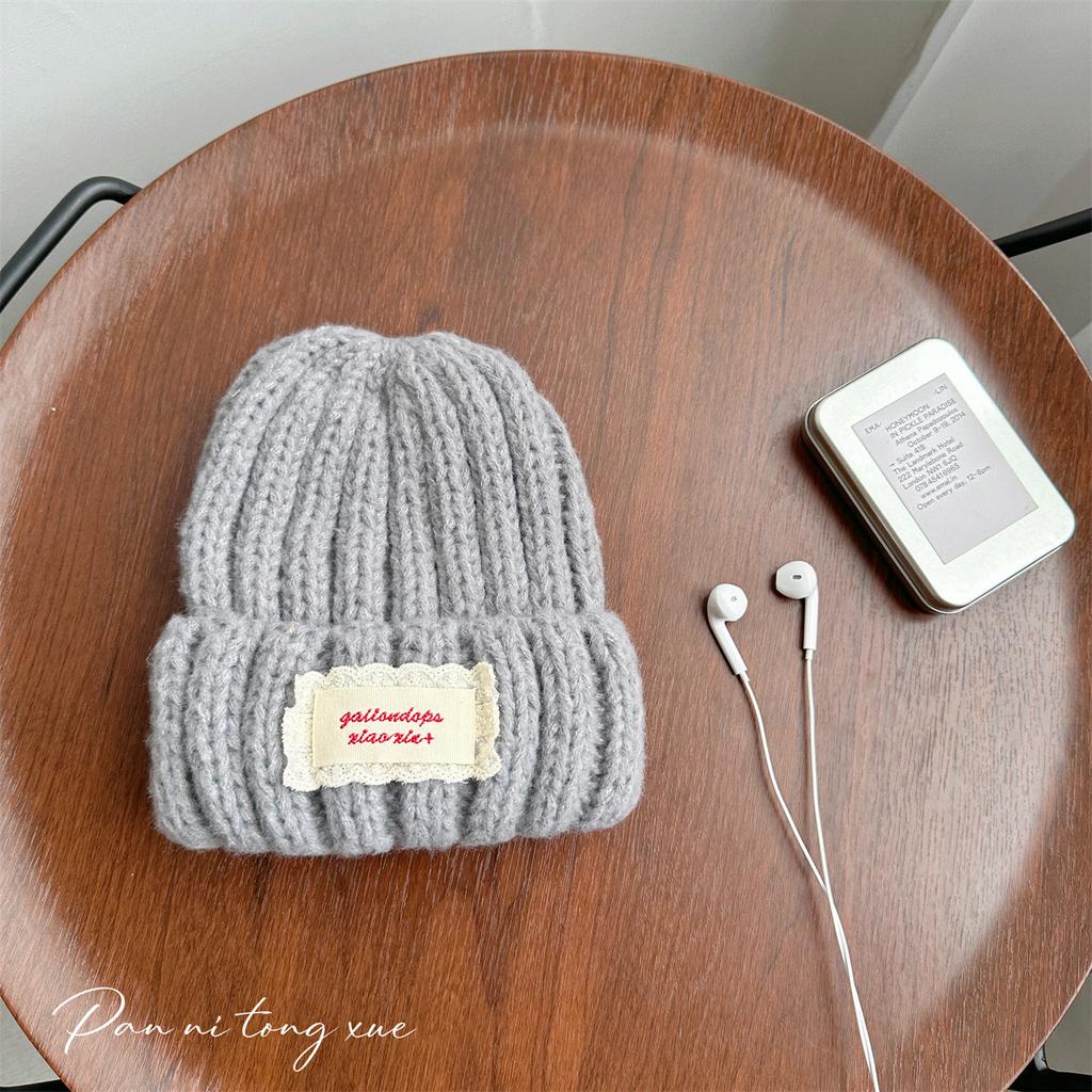 Neue Spitze Etikett Kinder Wollmütze Nuojiji Student Herbst und Winter Neu Warm und Vielseitig Ohrenschutz Strickmütze