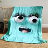 A playful turquoise face with large eyes, long lashes, and an open mouth. for all seasons blanket lunch break throw gift