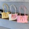 Soft and Sweet Young Lady Carrying A Fashionable Butterfly Knot Shoulder Bag On Her Arm with A Tote Bag.