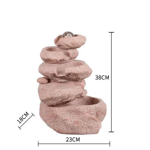 

Каменистый фонтан с водой, стол для передачи денег перед открытием колеса тайфуна для отправки подарков красный