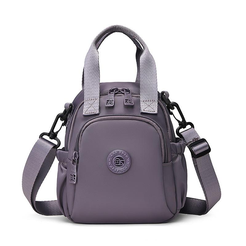 Kompakt Nylon Crossbody Miniryggsäck med Topphandtag Casual Liten Dagryggsäcksväska för Kvinnor Daglig Resa