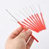 DIY Bead Threading and Knotting Tool with Red Handle for Jewelry Crafting.