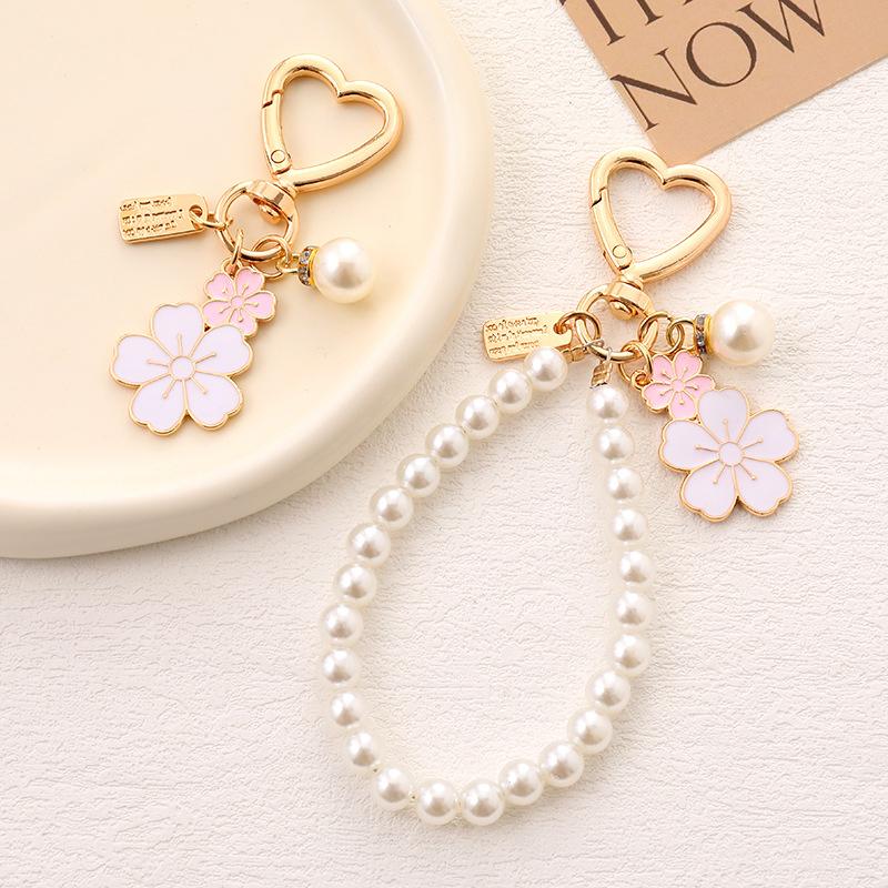 Süßer Damen-Schlüsselanhänger mit Perlen und Öltropfen, Weiß-Rosa Blumen, Goldene Buchstaben, Kopfhörerhülle mit Imitationsperlen, Tasche Zubehör