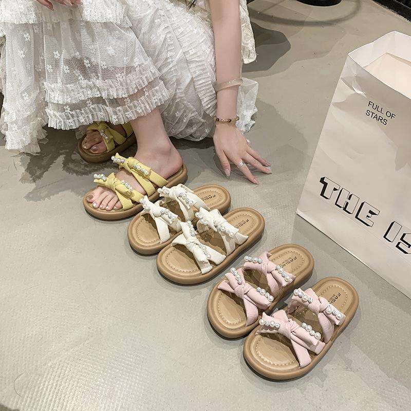 Zarte Schleife schöne coole Hausschuhe Damen Sommerbekleidung 2025 neu mit Rock Strand weiche flache Sohle Ein-Wort-Hausschuhe