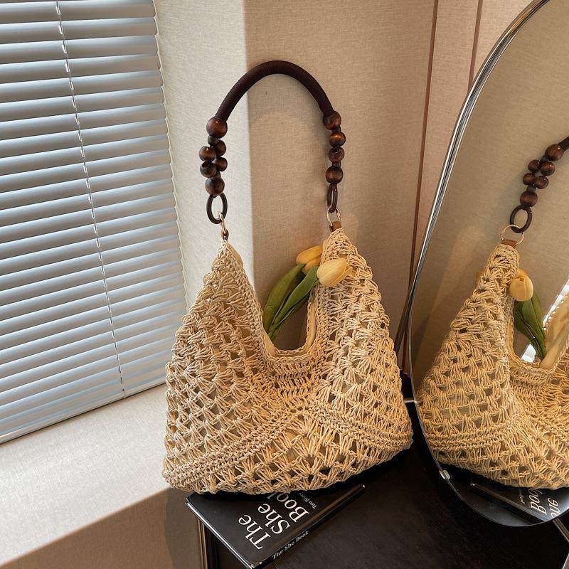 Sommer beliebte gewebte Tasche Damen neue Mode hohl tragbare Umhängetasche Strandurlaub Tragetasche