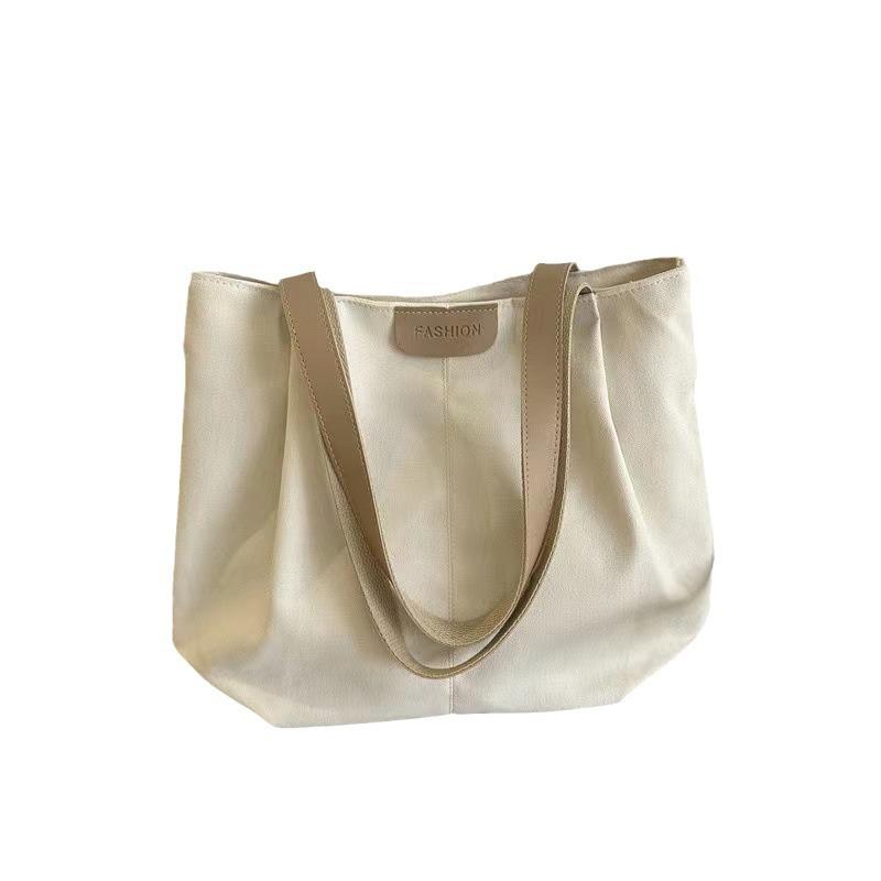 Women's new one-shoulder handbag, separated tote bag, large-capacity hand-carried canvas bag.