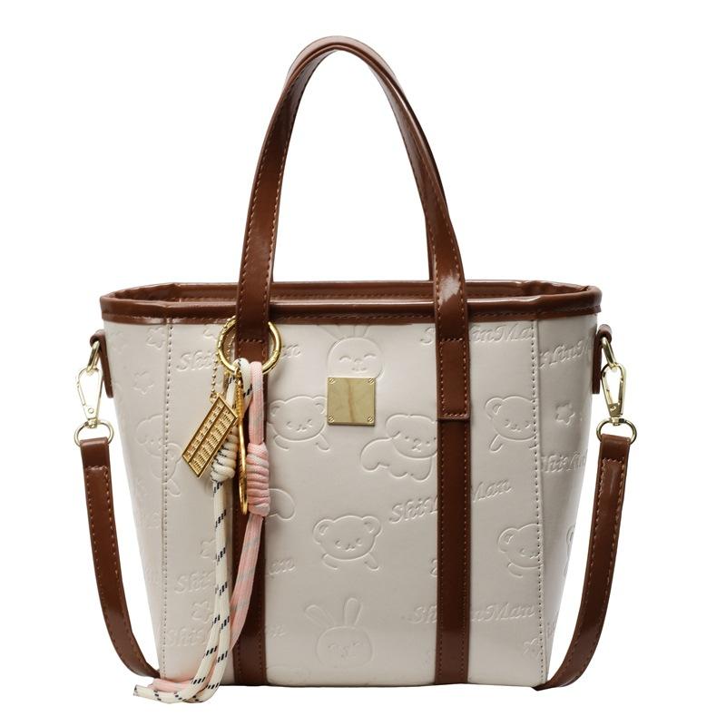 Korean version of high-end fashion and cute embossed portable bucket bag, women's commuting versatile foreign style messenger bag