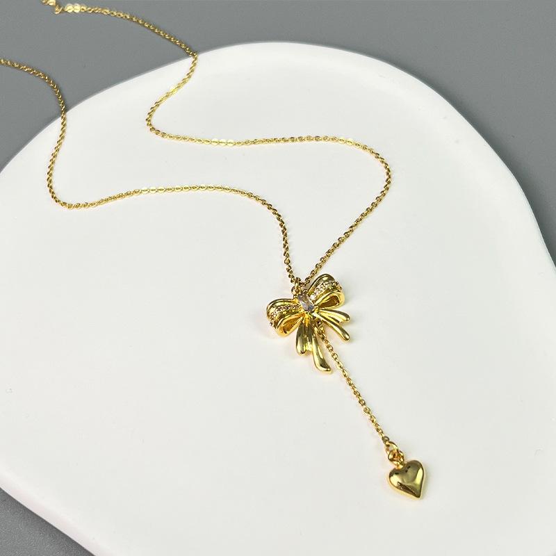 

Shijia Inspired Pearl Necklace: Bowknot & Heart Pendant - Elegant Spring/Summer Women s Jewelry