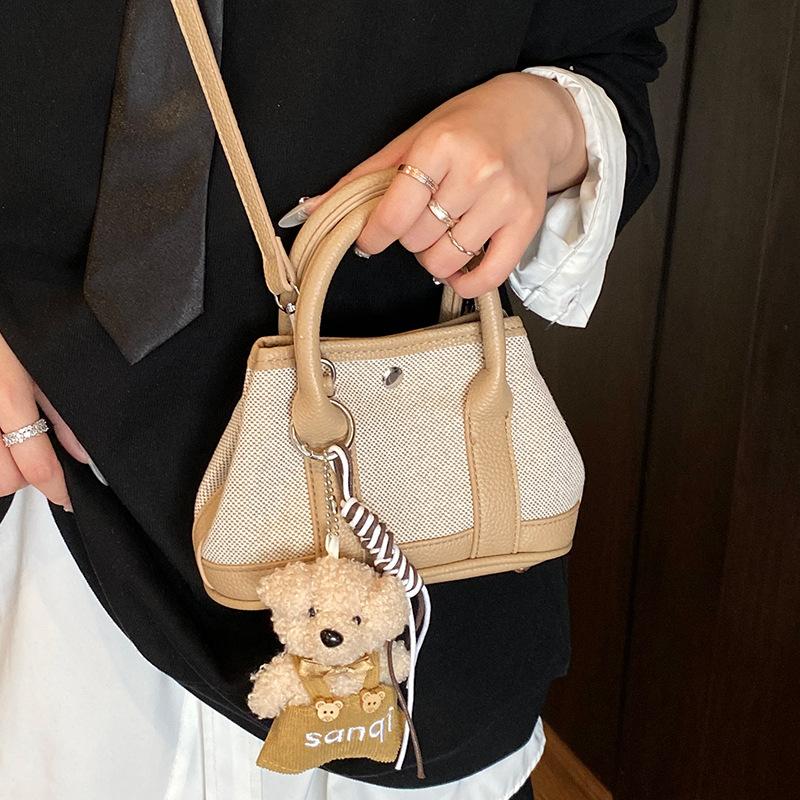 Korean version of casual niche contrasting color splicing portable bucket bag fashion versatile temperament casual commuter messenger bag woman