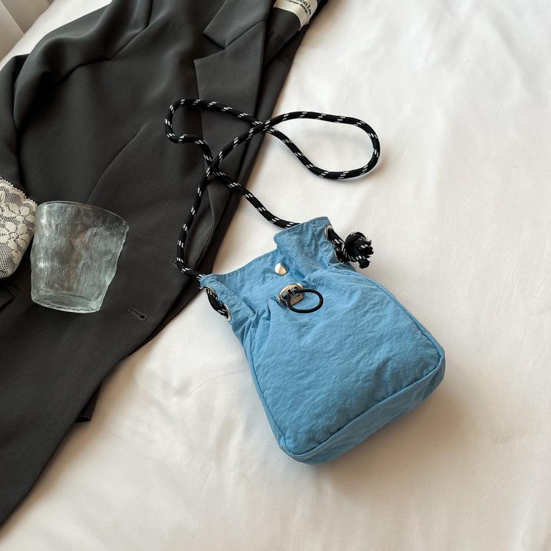 2025 New Japan and South Korea literary single shoulder messenger bag drawstring small bag niche sense fashion high value mobile phone nylon bag women