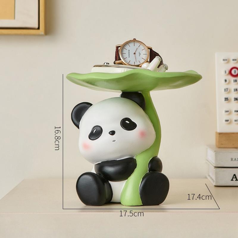 

Adorable red panda figurine holding a lotus leaf tray, practical decor for office or home interior, ideal housewarming gift.