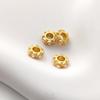 Color-preserving copper-plated matte gold flower-shaped spacer beads with imitation pearl inlay for DIY jewelry.