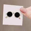 black sunglasses with gold brooch