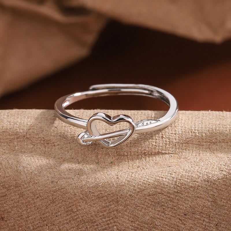 

Exquisite New Year Style Hollow Heart Ring: Trendy Woman s Design with Arrow Through the Heart. Adjustable