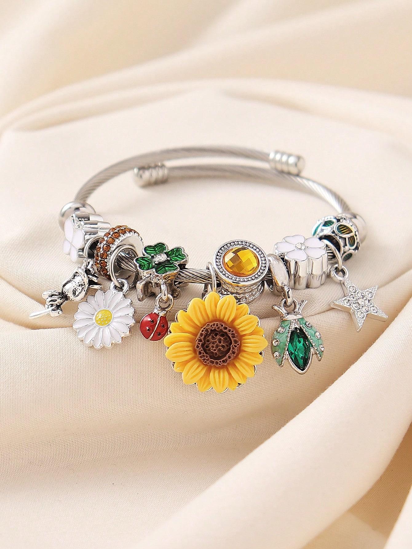 

A stainless steel rhinestone flower, star, rose, daisy, sunflower, and beetle pendant bracelet suitable for everyday wear.