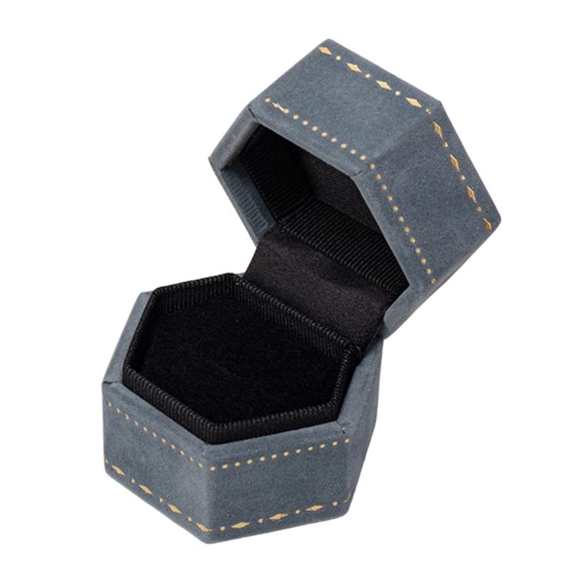 Hexagonal Ring Presentation Box with Black Interior, Gold-Tone Border Pattern, and Attached Lid for Retail Display