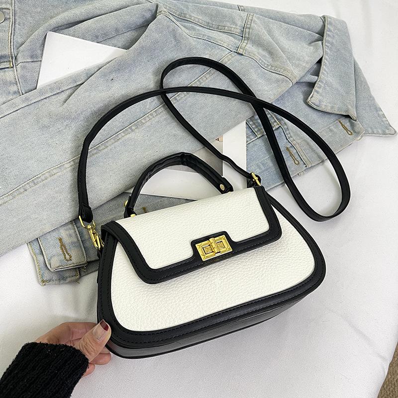 Spring niche design fashionable contrasting color saddle bag portable shoulder crossbody trendy women's bag