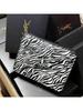 YSL Makeup Bag, Featuring a Zebra Print Design and Zipper Closure, Suitable for Everyday Use, Work, Travel, and School.