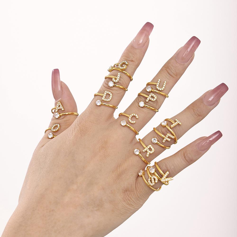 Oumeika Titanium Steel Jewelry Set: 26 Zircon-Inlaid Letters, PVD Gold-Plated Necklace, Bracelet, Earrings, and Ring.