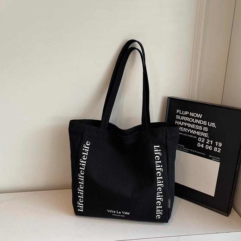 

New Canvas Top Handle Bag Simple Letter Print Casual Shoulder Bag for Women Travel Textured Casual and Versatile Commuting Bag