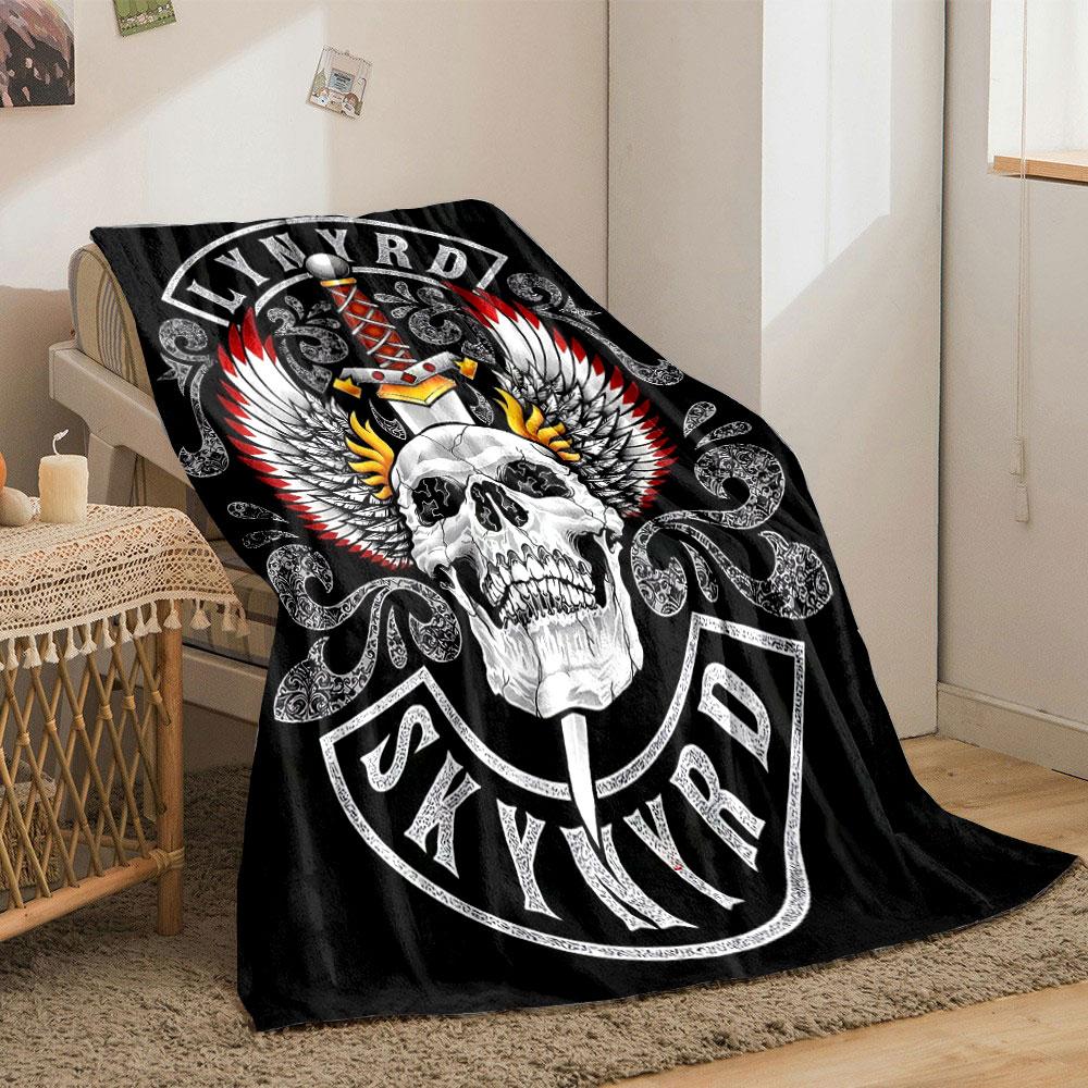 A skull with flaming wings and a sword, framed by intricate patterns. for all seasons blanket lunch break throw gift