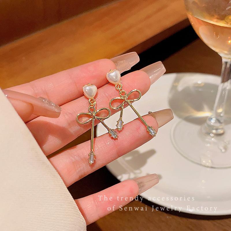 

Korean sweet bow earrings women s ins style niche design sense pearl love stud earrings summer temperament earrings