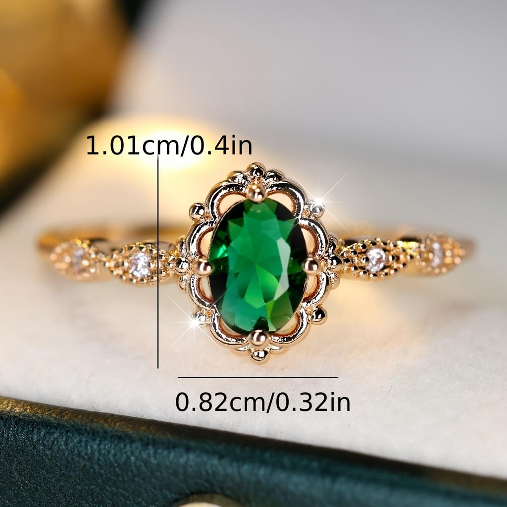 A ring inlaid with egg-shaped green synthetic zirconia, featuring a lace design, is elegant, simple, classic, exquisite, fashionable, luxurious, and