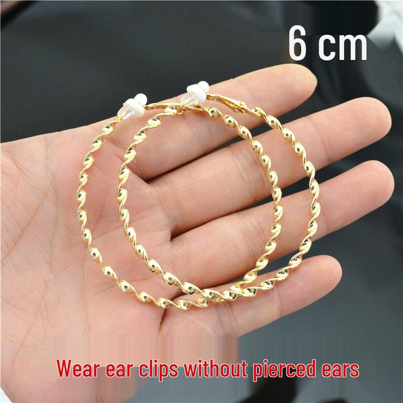 

Женские блестящие серьги-клипсы в виде перекрученных кругов - золото и серебро, не требуют прокола