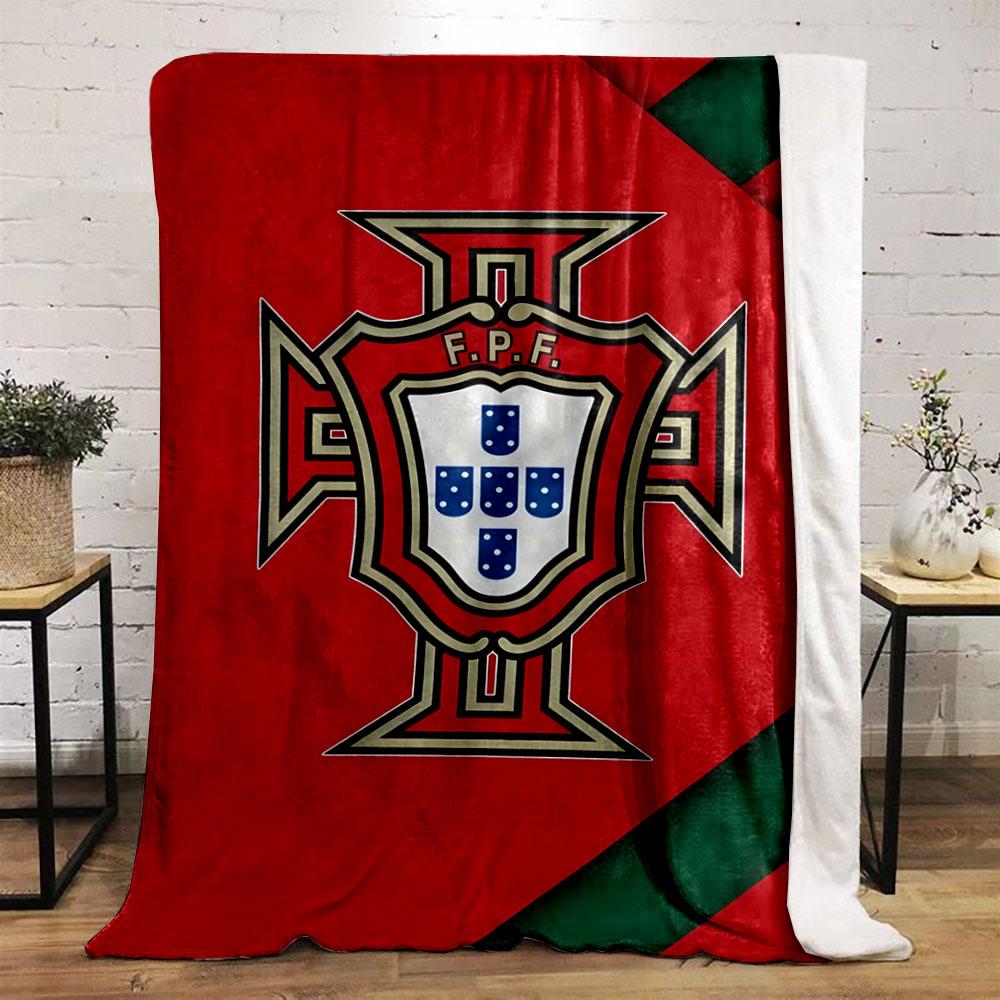 A red background with a central badge featuring a shield and cross design. for all seasons blanket lunch break throw gift